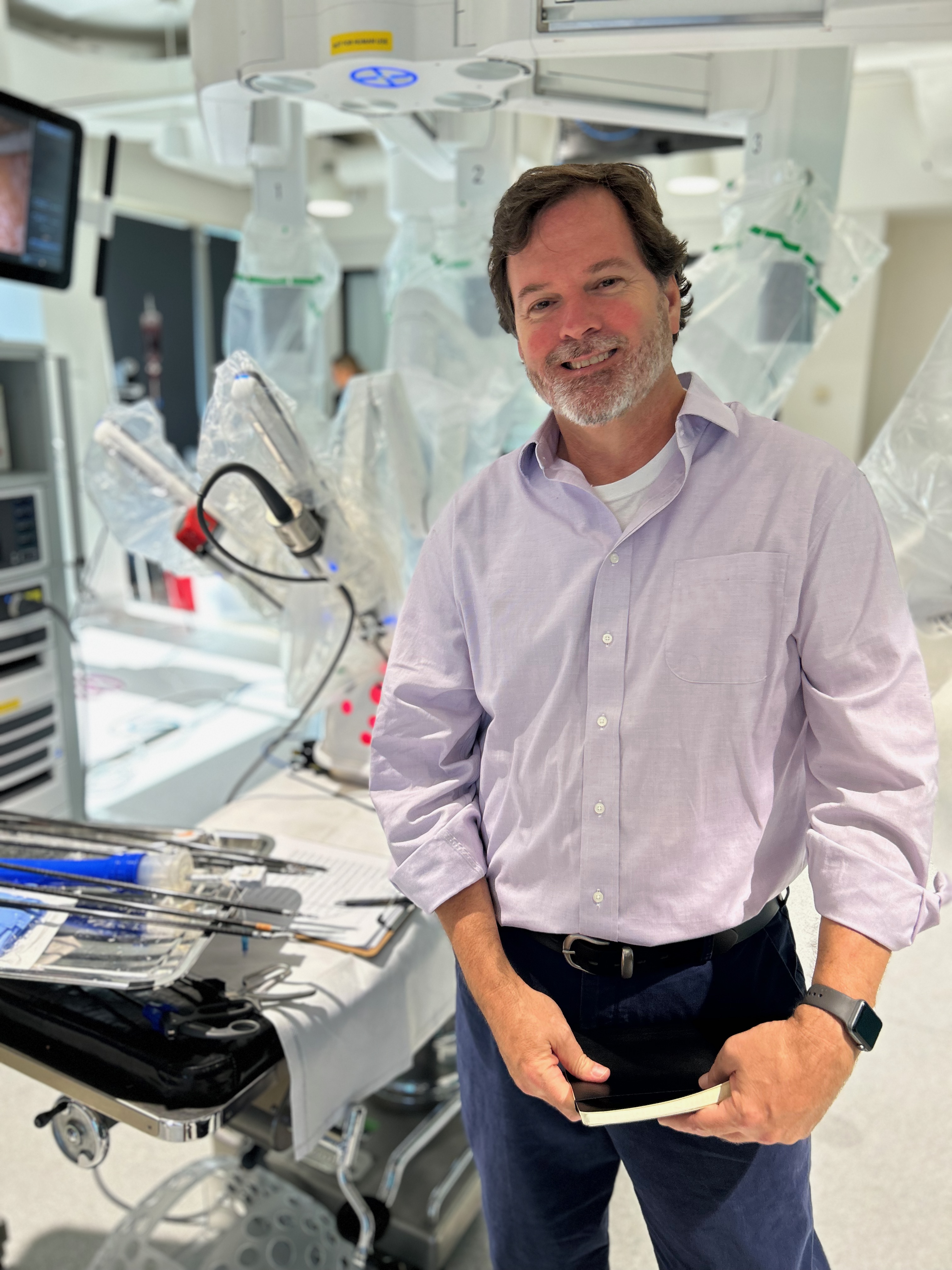 Richard J. Doherty standing in a robotic-surgery suite, the environment of his applied-ML work in regulated medtech
